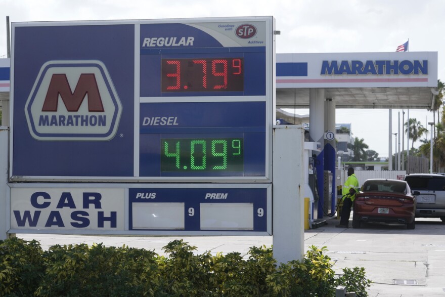 A customer pumps gas at a Marathon gas station, Tuesday, Aug. 22, 2023, in North Miami.