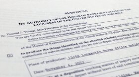 A close up of a paper copy of the subpoena of Donald J. Trump. 