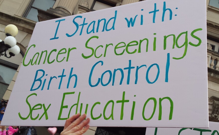 Supporters hold signs at rally