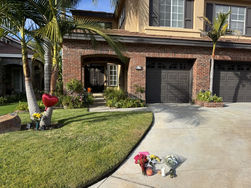 Tributes lay at the home of a Simi Valley doctor and his wife who were murdered