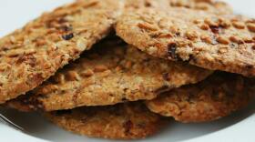 Brown round cookies served on a white ceramic plate.