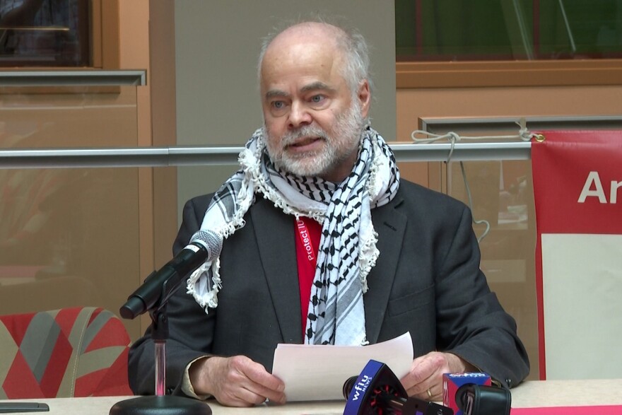 Indiana University professor Ben Robinson talks at during a "Day of Action" press conference on April 17.