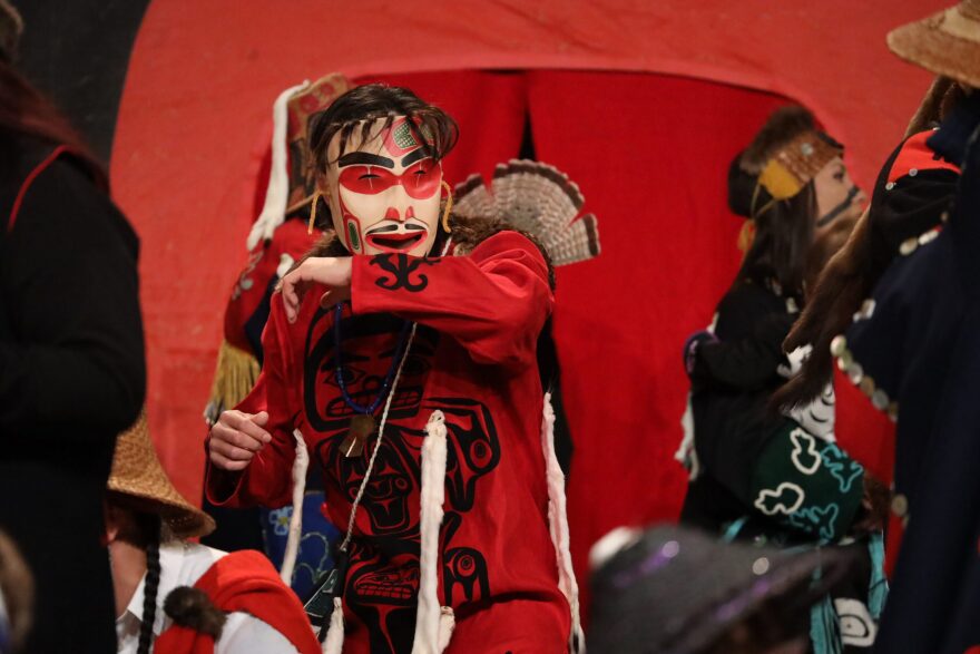 people dance in the streets in traditional clothing and masks for a celebration
