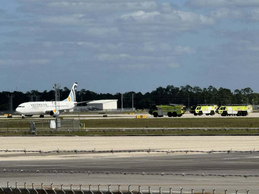 Eastern Air Express plane surrounded by emergency vehicles at Southwest Florida International Airport on Saturday.