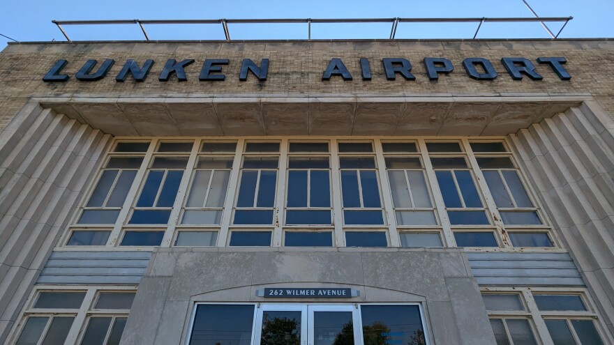 A brick building with windows. Lunken Airport is in large letters near the top.