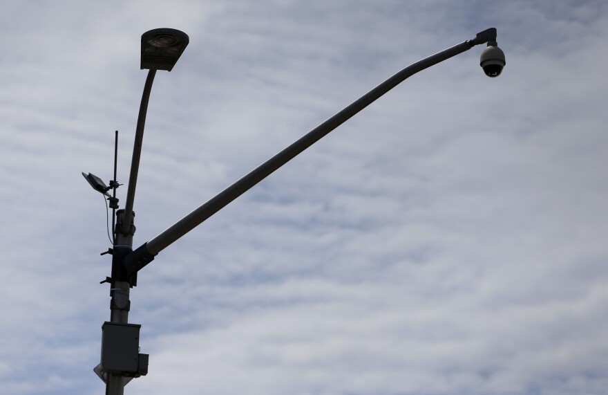 In this Wednesday, April 29, 2020 photo, a surveillance camera is seen on a light post at a street corner in West Baltimore. The Peoria chapter of the ACLU is calling on the city council to require more oversight and transparency for the police department's new Automatic License Plate Reader camera system.