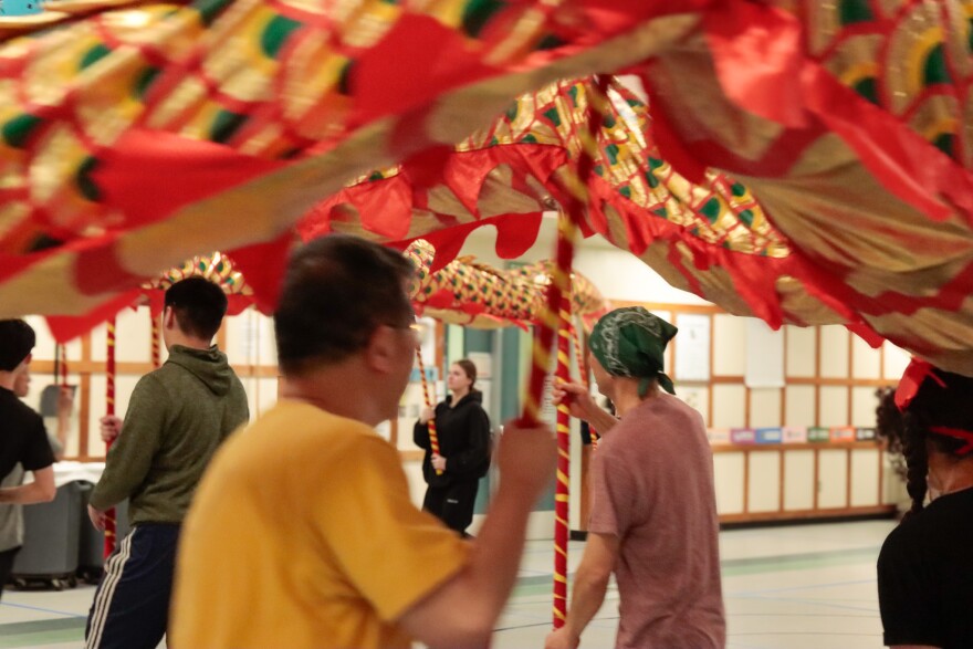 People practicing the dragon dance, a traditional Chinese art form.