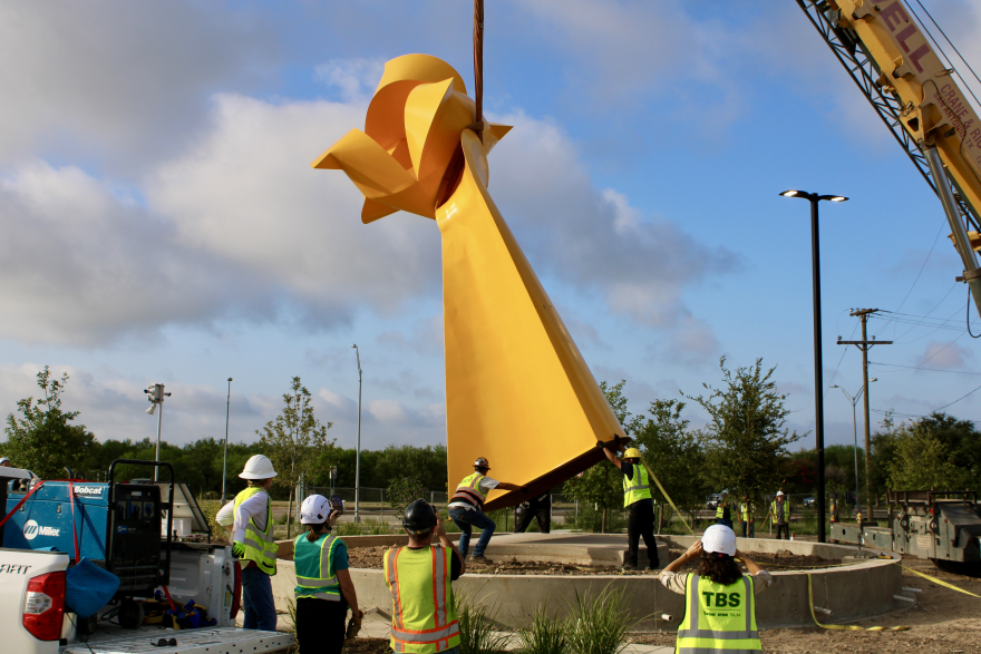 Workers place the Flor de Esperanza sculpture at the site of the University Health Palo Alto Hospital.