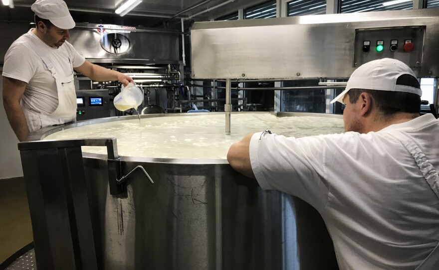 Workers in the Russky Parmezan (Russian Parmesan) dairy prepare cheese. Sirota says almost all equipment in the factory is Russian-made.