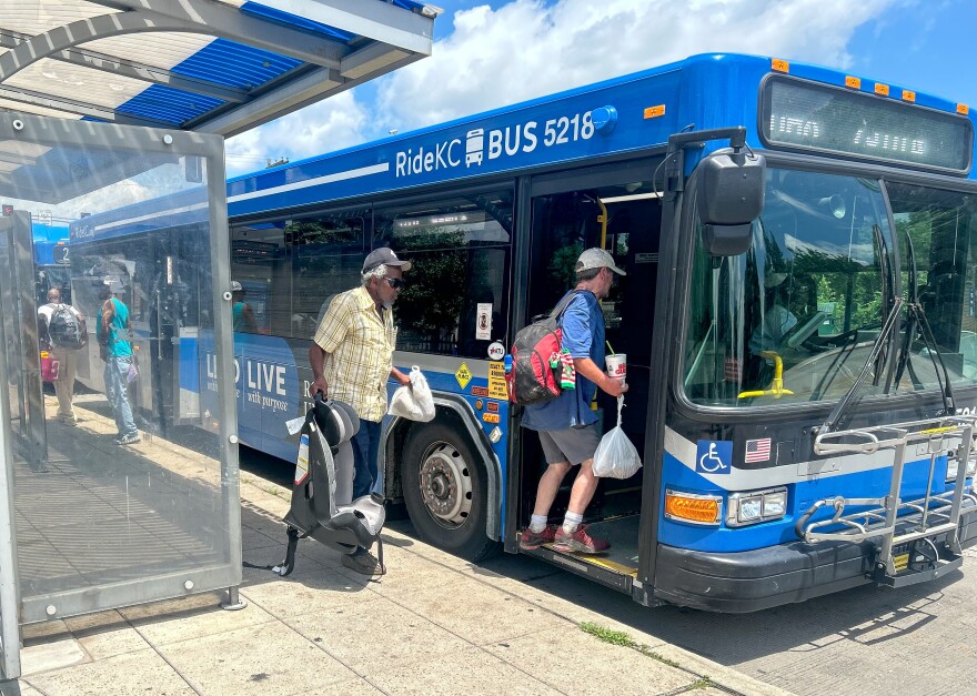 Residents board a bus heading southbound on Troost Avenue.