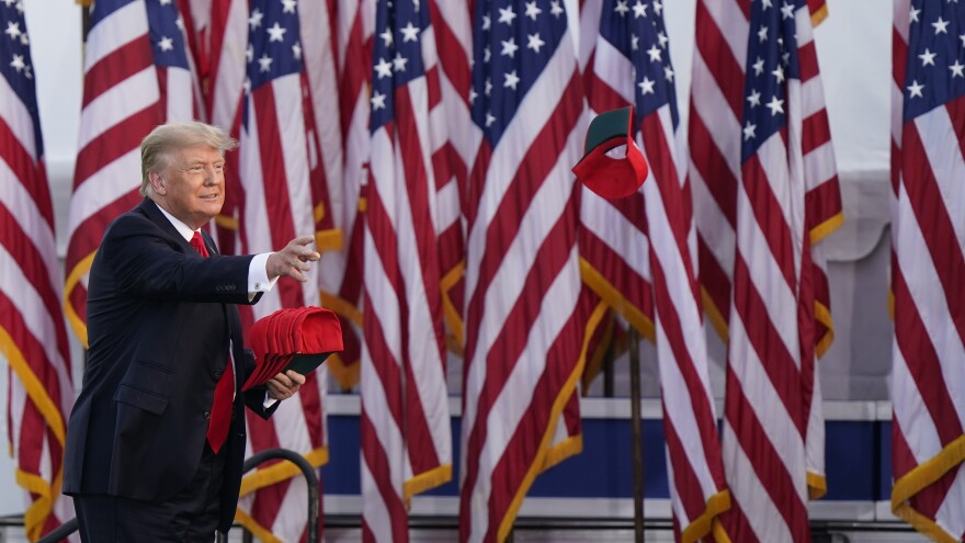 Former President Donald Trump throws a "Save America" hat before speaking at a rally at the Lorain County Fairgrounds, Saturday, June 26, 2021, in Wellington, Ohio.