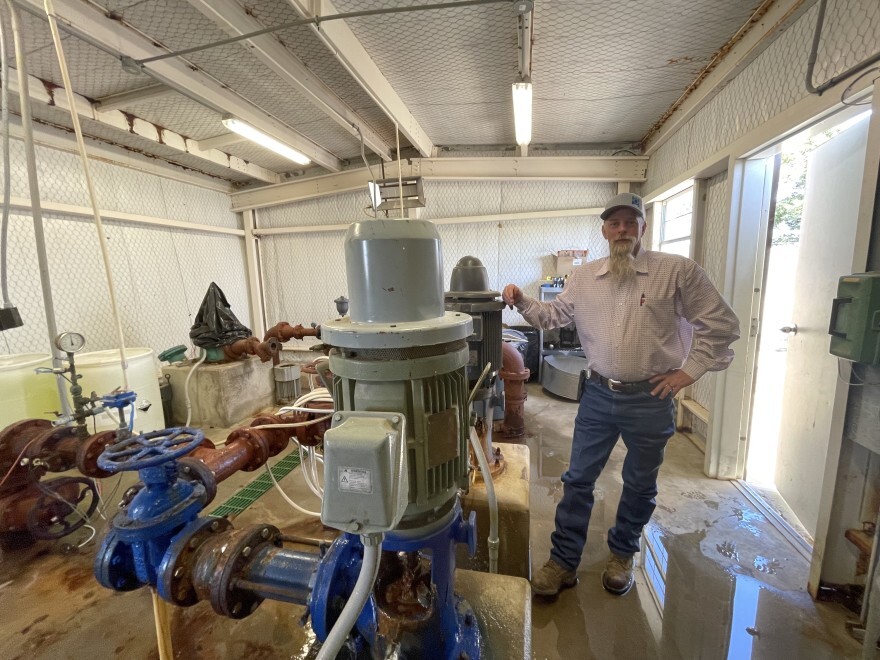 Sheldon Tatum, a rural water district manager in Hughes County, stands in a water well pump house. He says his system is old, and the increase in water demand might stress the old piping system.