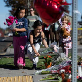 Children place flowers at a makeshift memorial outside Silver Rail Elementary in Bend, Oregon, Friday, Oct. 16, 2026, a day after a deadly shooting. (Joe Kline/AP)