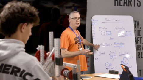 Patrick Andries instructs students at a Bixby High School robotics class on Sept. 8, 2026. The student is sophomore Sullivan Hughes.