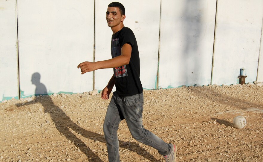 Ishaq, 19, still loves to play soccer with his family and friends.