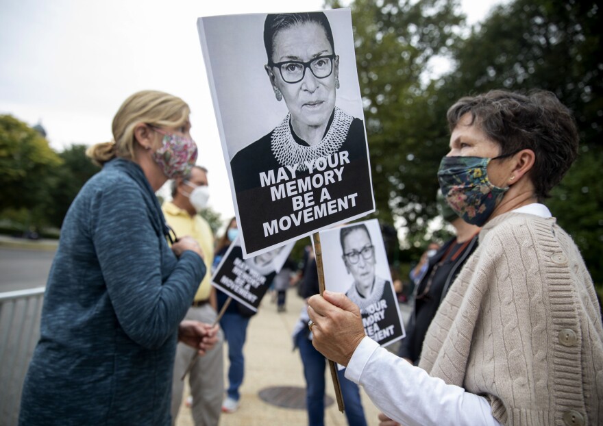 From left, friends Sharon Gellin and Jennifer Howard, of Washington D.C., stand across the street from the Supreme Court with images of RBG.