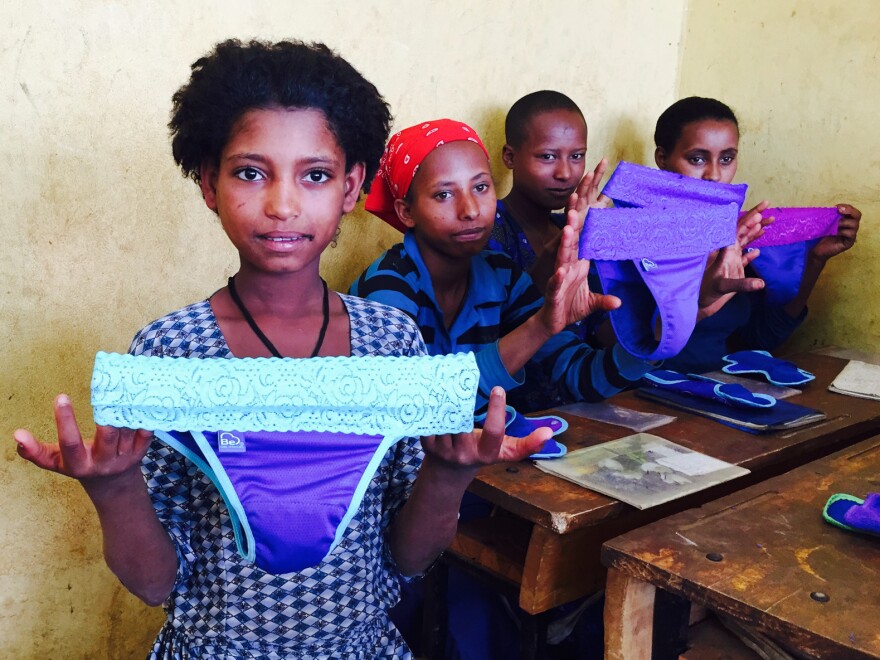 Schoolgirls in Ethiopia examine a new feminine product: underwear with a pocket for a menstrual pad.