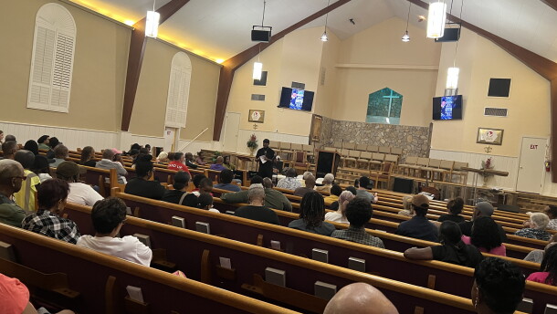 People gather in Greater Peace Missionary Baptist Church for a town hall meeting