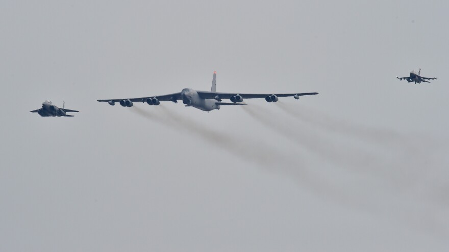 A US B-52 Stratofortress is escorted by a South Korean fighter jet (left) and a U.S. fighter jet (right) as it flies over the Osan Air Base in Pyeongtaek, south of Seoul, on Sunday.