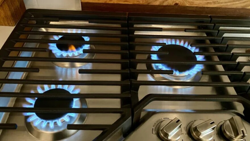 Gas-lit burners are ignited on a natural gas stove, Dec. 26, 2025, in Erie, Colorado. Colorado passed legislation requiring warning labels on gas stoves in June 2025. The warning labels, which are being challenged in court by the gas industry, are similar to what is required by cigarette labeling laws.