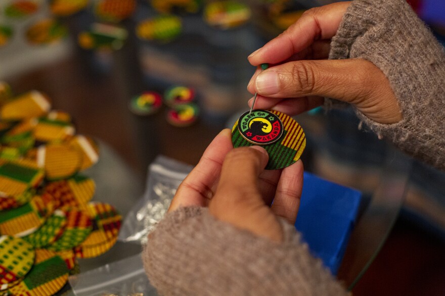 Jan Miles makes earrings for the Women of Wakanda sub-krewe to toss out to spectators along the parade route.