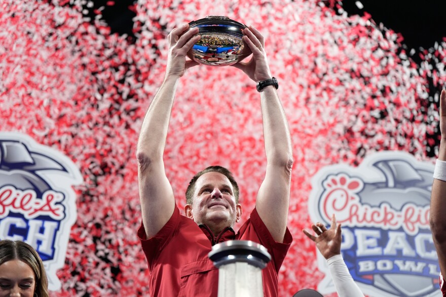 Indiana head coach Curt Cignetti holds up the trophy after the Peach Bowl NCAA college football playoff semifinal against Oregon, Friday, Jan. 9, 2026, in Atlanta. (AP Photo/Brynn Anderson)
