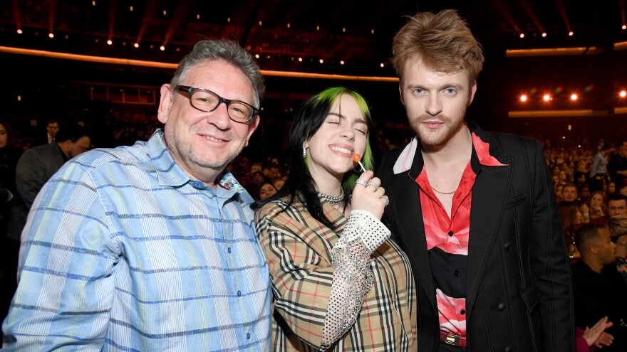 From left: Lucian Grainge, CEO of Universal Music Group; artist Billie Eilish; and Eilish's brother, songwriter Finneas O'Connell — photographed during the 2019 American Music Awards at Microsoft Theater on Nov. 24, 2019 in Los Angeles.