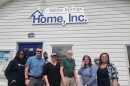 people stand outside a building, posing for the camera.  From left, Miles Taylor, Antioch College Student Miller Fellow (2025); Chris Hall, Program Manager; Emily Seibel, Executive Director; Tom McCaffrey, Client-First Specialist; Brittany Keller, Development Coordinator; Alexandra Scott, Outreach & Fundraising Manager.
