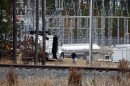 Workers work on equipment at the West End Substation, at 6910 NC Hwy 211 in West End, N.C., Monday, Dec. 5, 2022, where a serious attack on critical infrastructure has caused a power outage to many around Southern Pines, N.C.