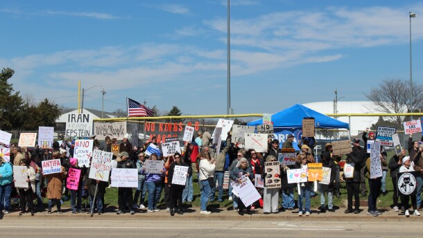 Along War Memorial Drive near Peoria Stadium demonstrators hold signs and protest the Trump administration. 