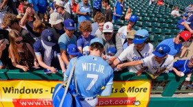 Bobby Witt Jr. signs autographs before a spring training baseball game against the Chicago Cubs, Monday, Feb. 23, 2026, in Surprise, Ariz.