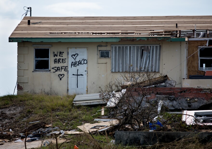 Residents of Marsh Harbour who survived Hurricane Dorian leave messages on their door to let loved ones and officials know they are OK.