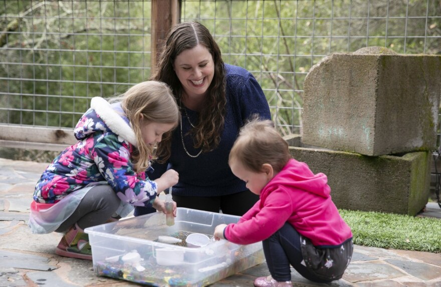 Gennie Gorback, President-Elect of the California Kindergarten Assocation, plays in the backyard with her daughters Tilly, 4, left, and Cece, nearly two, right, at their home in Orinda on Feb. 3, 2021. Tilly has been doing online preschool this year.