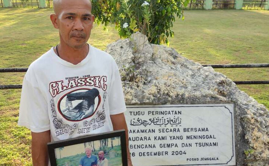 Sabari, who lives in Lhoknga, lost his wife and child in the tsunami. He holds a portrait of himself with former U.S. President Bill Clinton, who visited the area. Sabari is one of the many people in the area who are still suffering from the trauma of their losses.