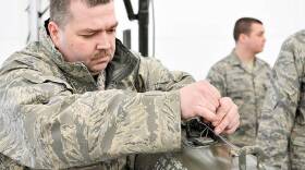 In this photo taken March 10, 2012, Technical Sgt. David Costello uses a piece of tape to date the fuse wire on a munition in Fort Wayne, Ind. The date is put on the munition to identify the when it was made.