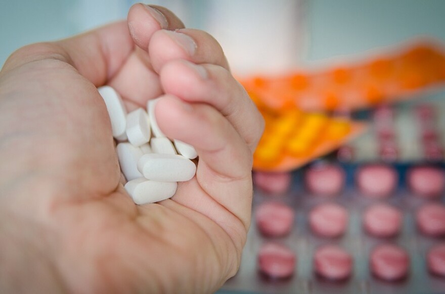 A stock image of a handful of pills