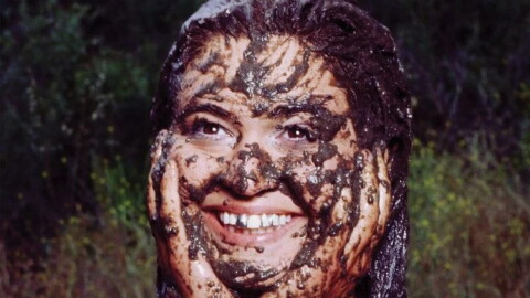 a woman covered in mud 