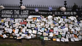 A fence outside Brooklyn's Green-Wood Cemetery is adorned with tributes to victims of COVID-19 in New York. The memorial is part of the Naming the Lost project which attempts to humanize the victims who are often just listed as statistics. (Mark Lennihan/AP)