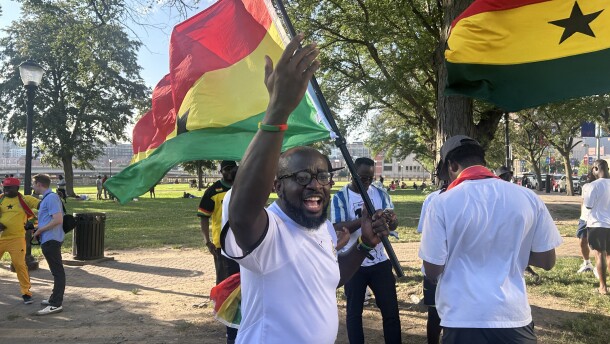 A Ghana fan pumps up others Thursday during a rally for the country's national team ahead of Friday's match against Colombia.