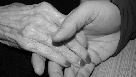 Holding elderly person's hand