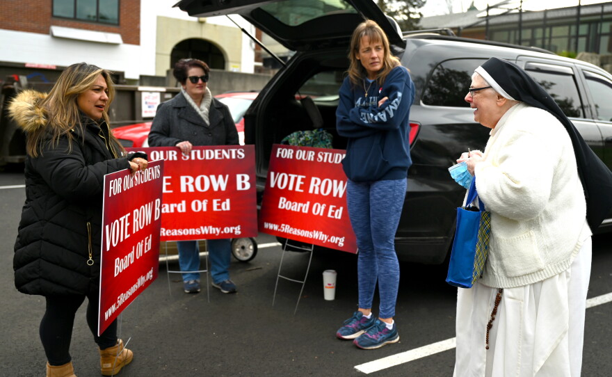 Conservative parents are standing outside debating with a nun from the Monastery of Our Lady Grace in Guilford