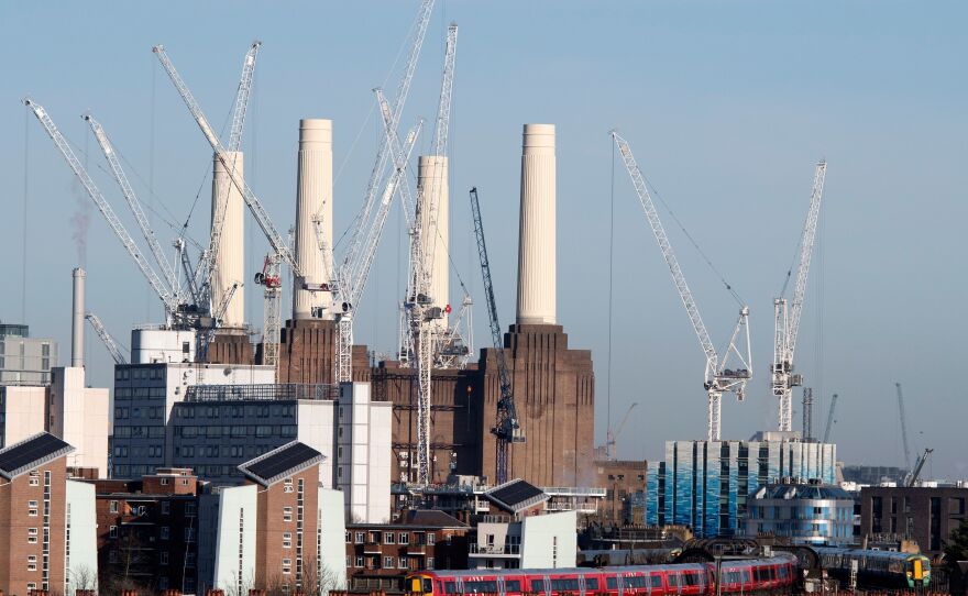 Passenger trains pass through Battersea Park rail station as construction work continues on the Battersea Power Station residential and retail development complex in London in December.
