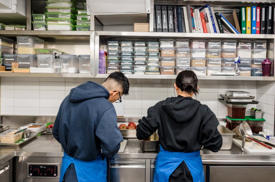 Staff prepare apples in Evett's kitchen.