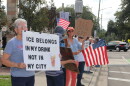 Valerie Fuldauer, 76, holds a sign with the words “ICE belongs in my drink not in my city.” (María Sofía Rodríguez/WUFT News)