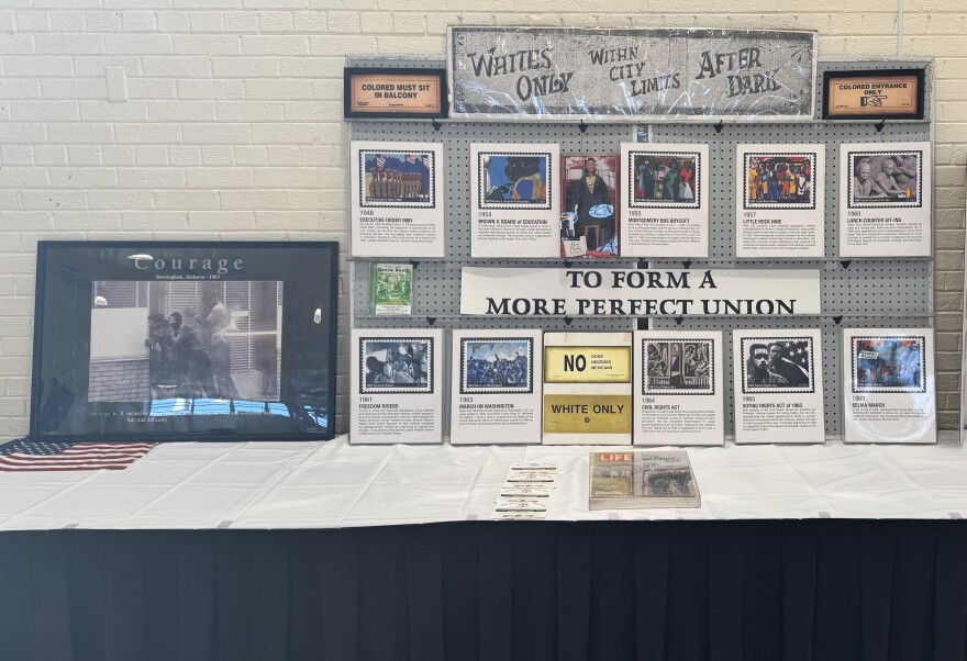 An exhibit table with photos and information