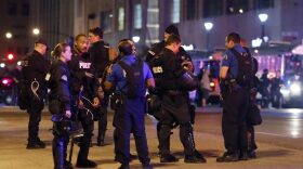 Police talk after multiple arrests were made following a protest in response to a not guilty verdict in the trial of former St. Louis police officer Jason Stockley Monday, Sept. 18, 2017, in St. Louis. Stockley was acquitted on Friday in the 2011 killing of a black man following a high-speed chase. (Jeff Roberson/AP)