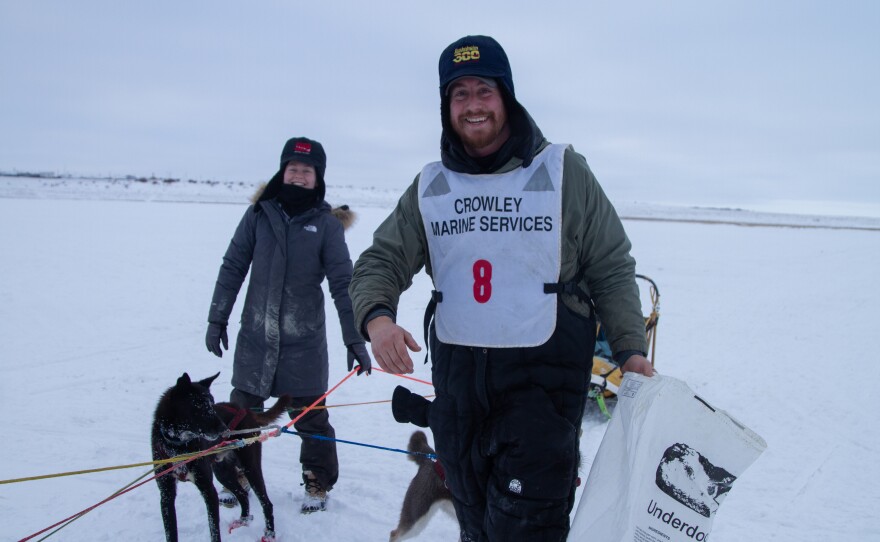 Rookie Spencer Wilson and handler Kylie Ford of Hardwick Kennels snack the dogs after Wilson's run.