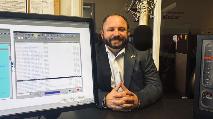 A photo of Jason Corley sitting in the KTTZ studio.