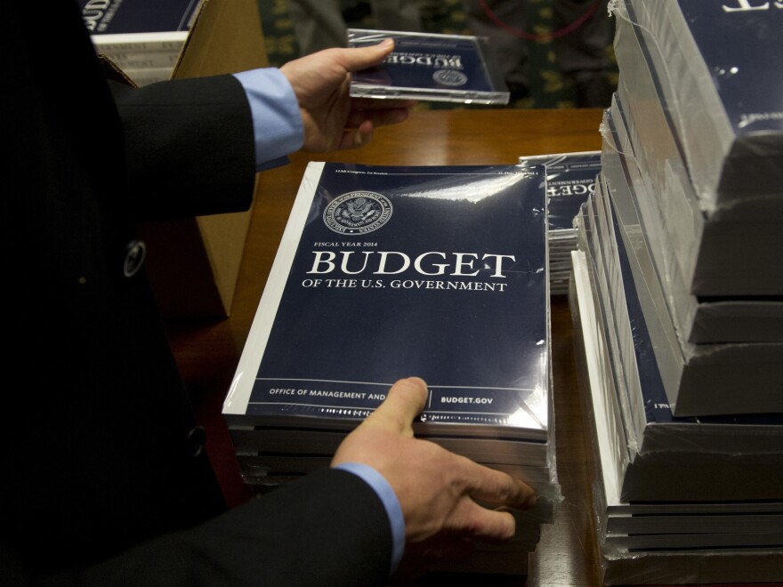 Senate Budget Committee staffers unpack boxes of President Obama's 2014 budget proposal on Wednesday.