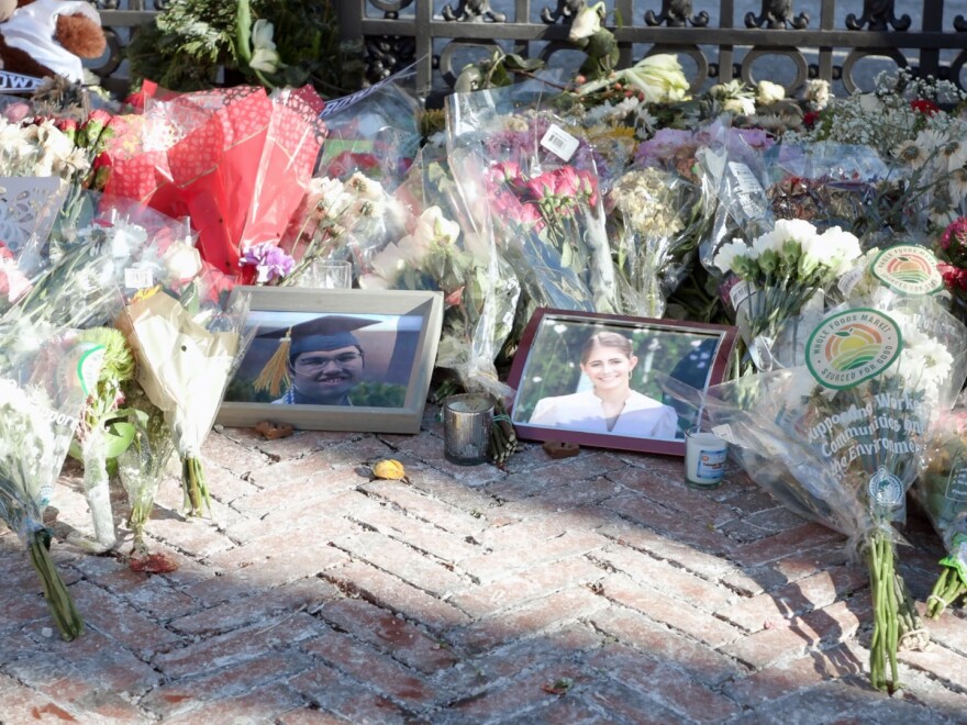 Photos of Mukhammad Aziz Umurzokov and Ella Cook, two victims of the mass shooting at Brown University, rest at a memorial at the Van Wickle Gates on the university campus on Dec. 16, 2025.